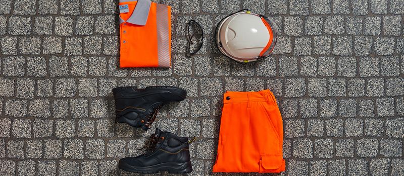 Collage of PPE - hard hat, shoes, orange trousers and orange hi-vis shirt