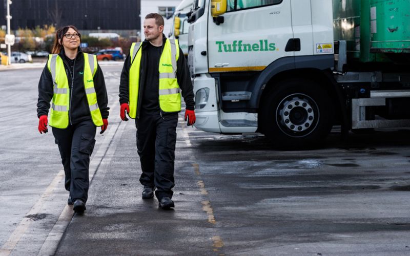Tuffnell employees in hi vis jackets walking away from a truck