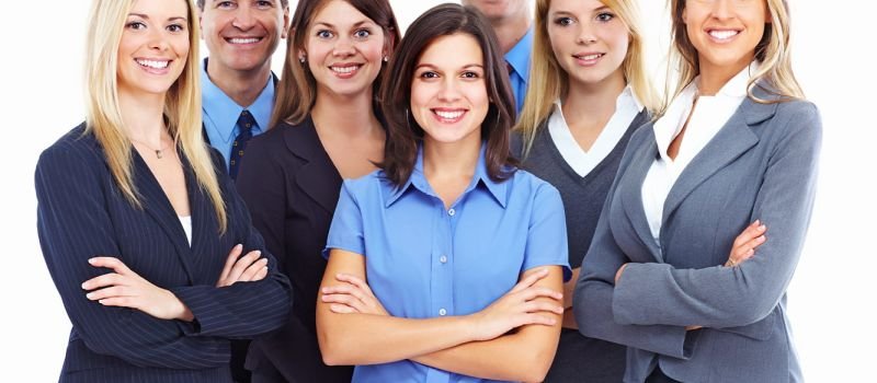 Small group of people in similar uniforms greys and blue, co-ordinated but different