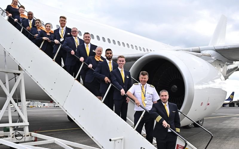 Hans airway staff lined up on steps going up to plane