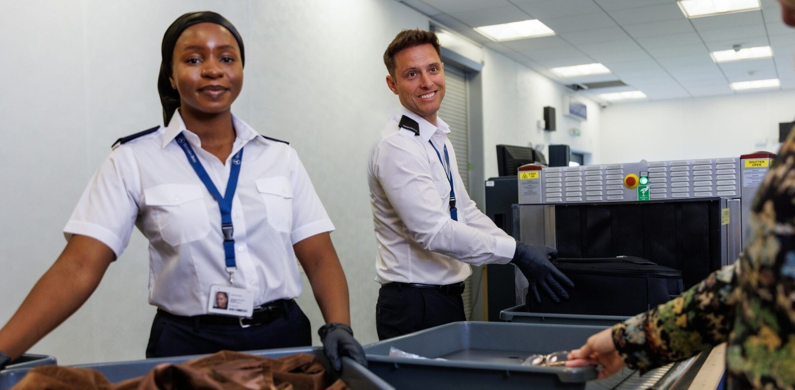 Male and female security officers working in security area