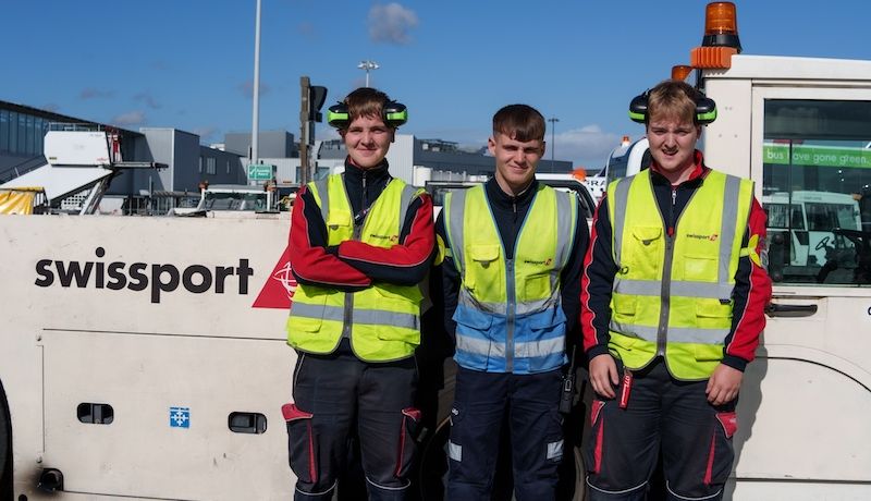 3 Swissport Ramp Agents next to a tow truck