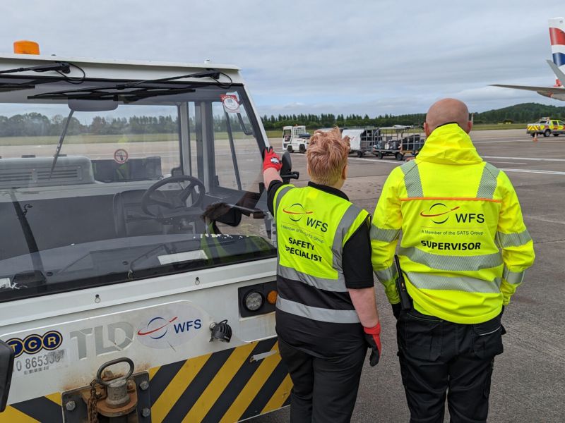 WFS staff looking at aircraft on ramp