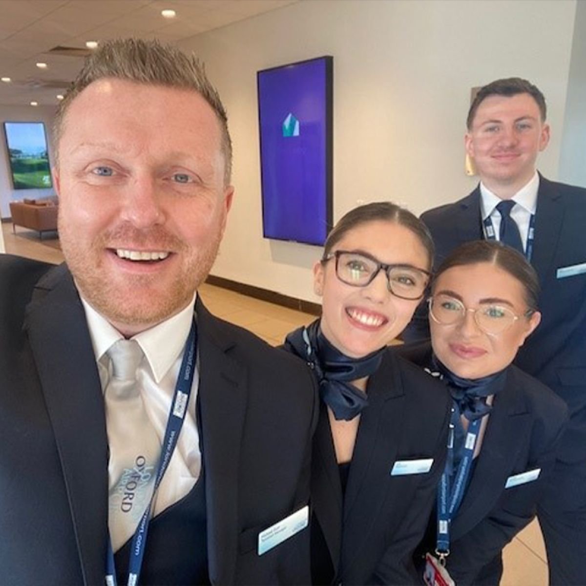 Staff at London Oxford Airport in new uniform - 2 men, 2 ladies - selfie style