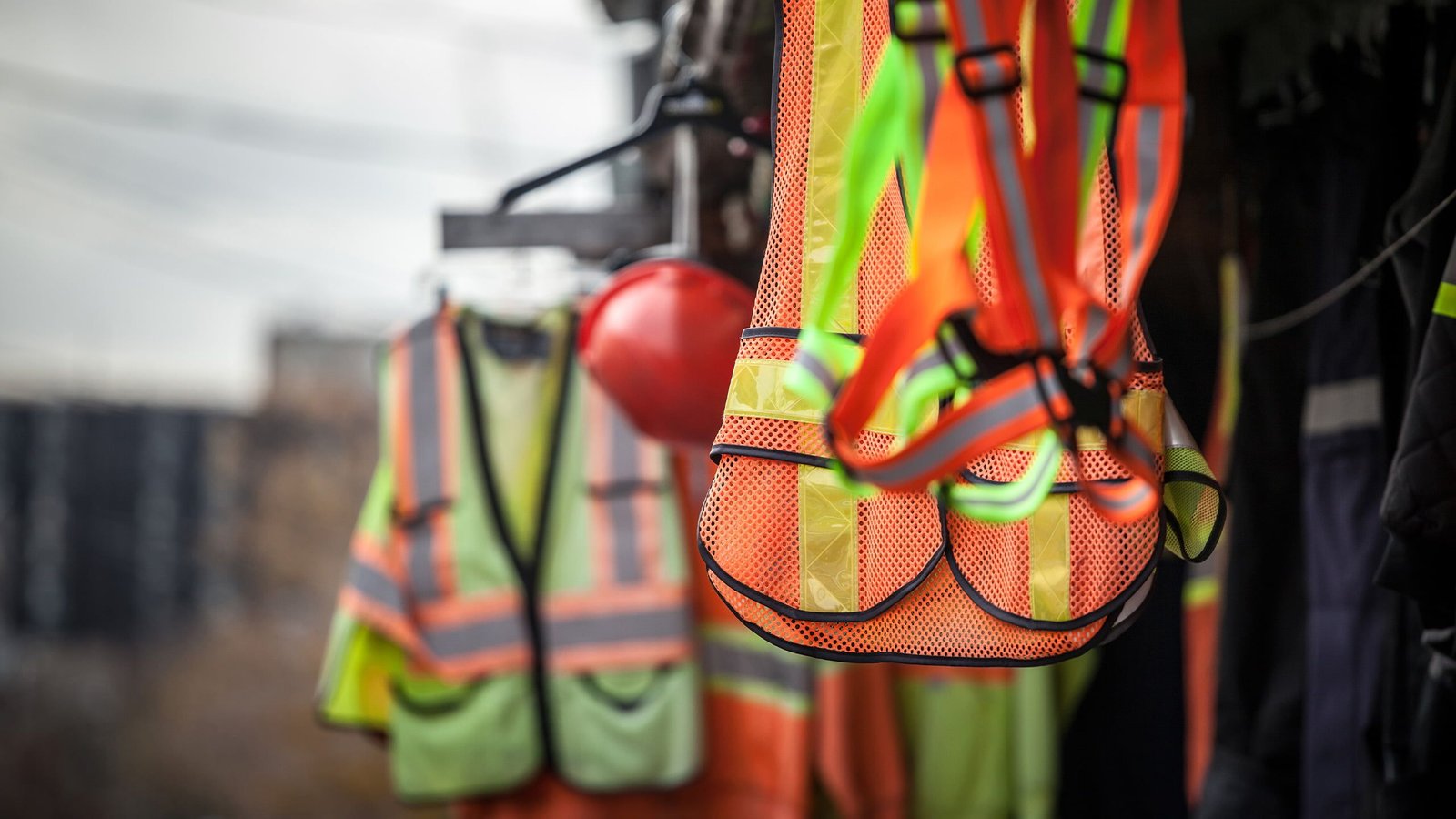 Set of PPE hanging in construction site setting.