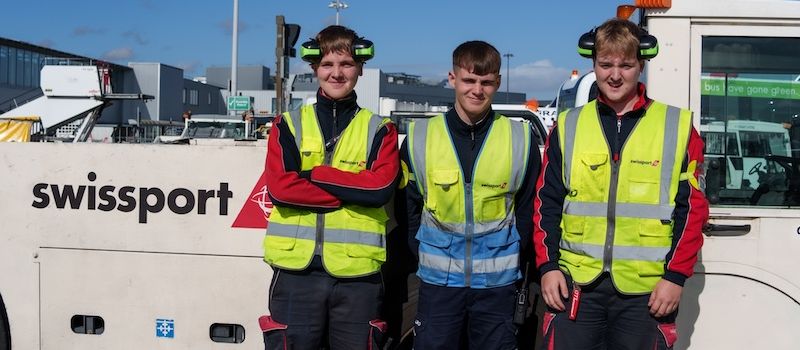 3 Swissport Ramp Agents next to a tow truck