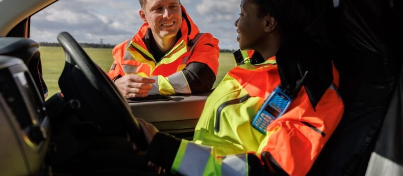 Airfield Operations employees talking on runway