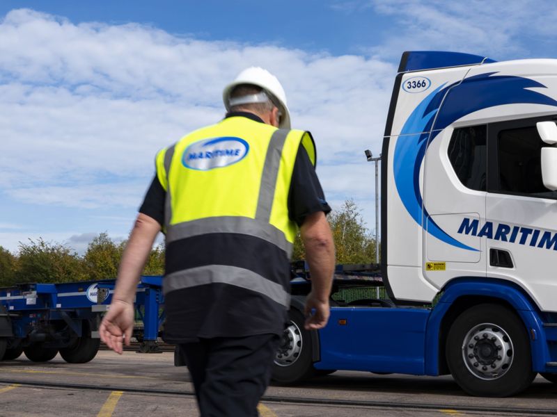 Man in hi-vis Maritime vest walking to his truck