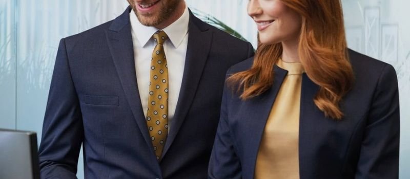 Male and female receptionist in smart suits